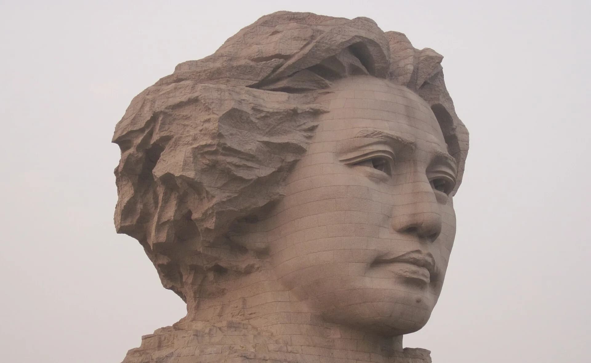 Cropped close view of the Young Mao sculpture on Orange Isle