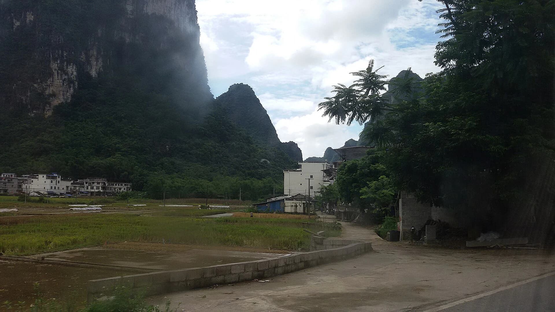 Farm plots and village landscape beneath Mingshi karst peaks