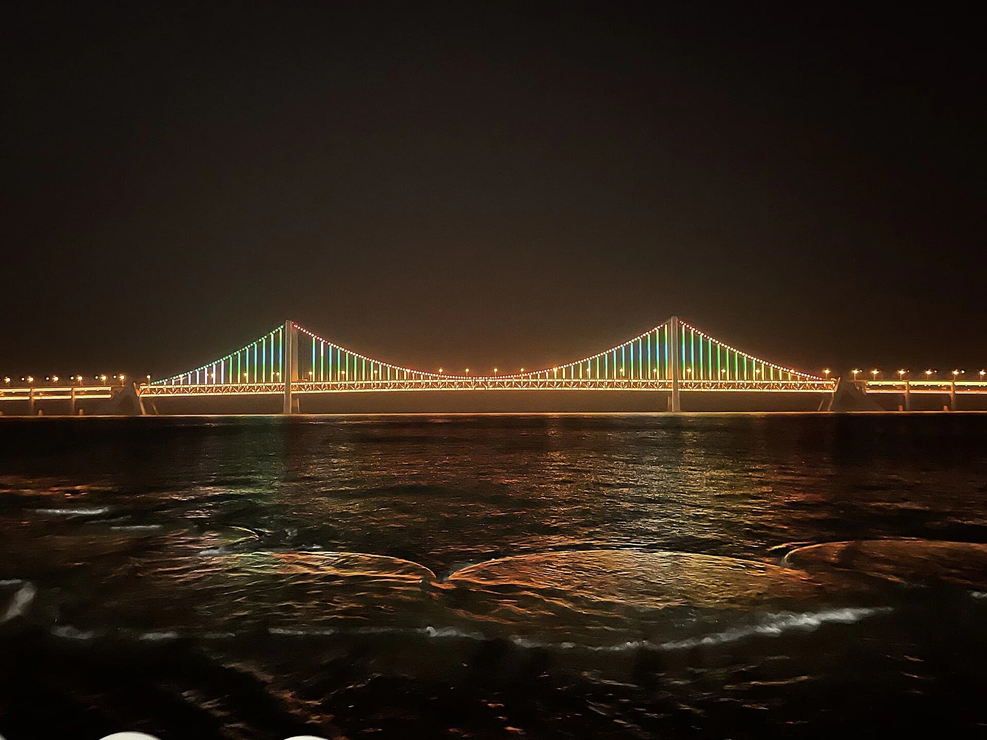 Xinghai Bay Bridge seen across Xinghai Square at night