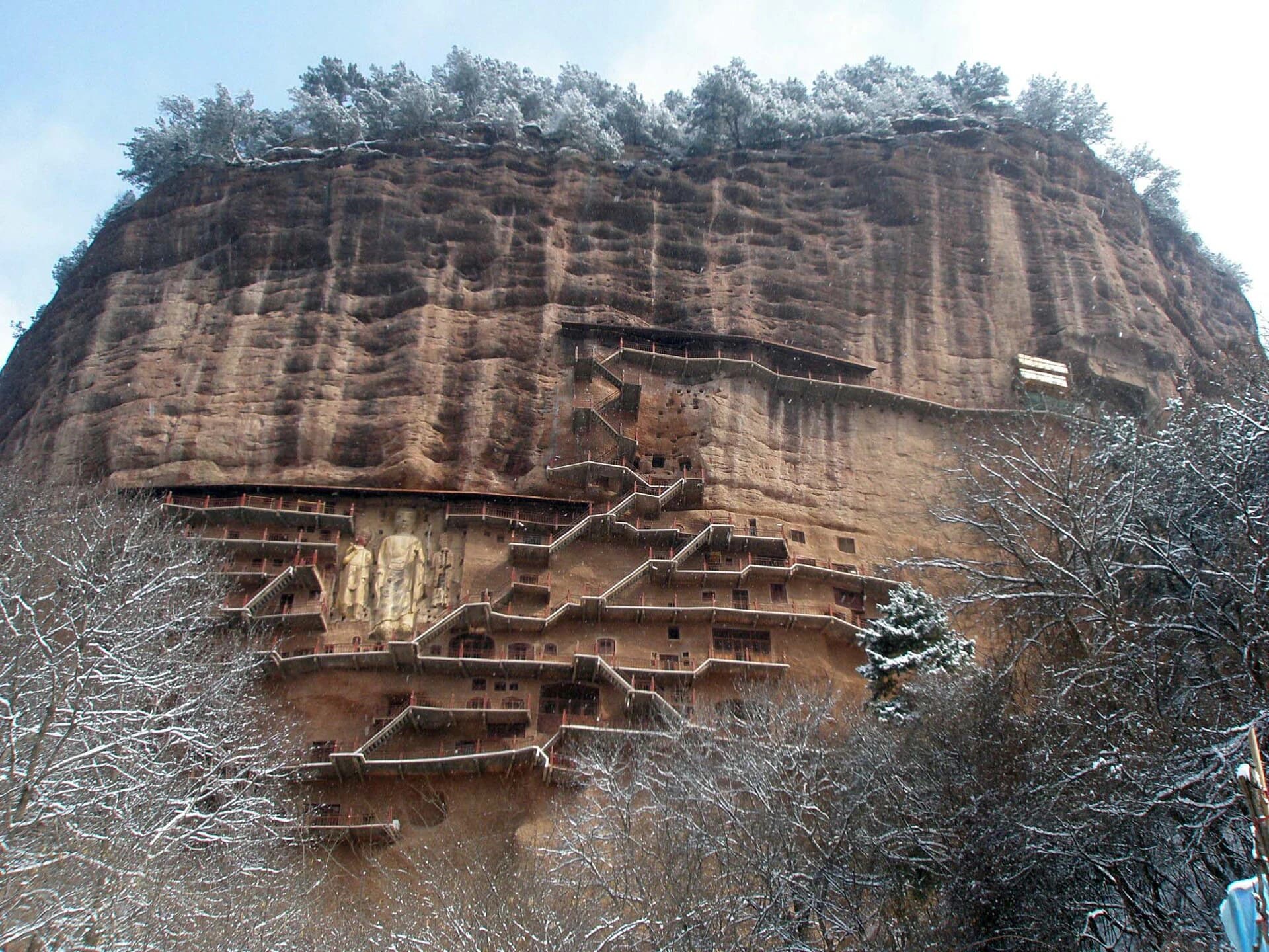 Cliff face and grotto walkways at Maijishan in winter