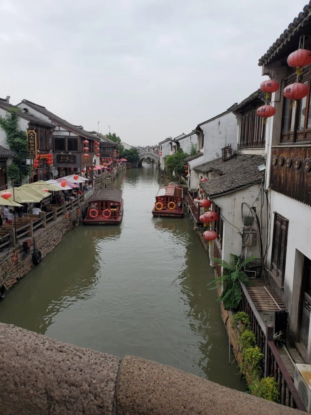 Canal diurno, casas tradicionales y barcos a lo largo de la calle Shantang