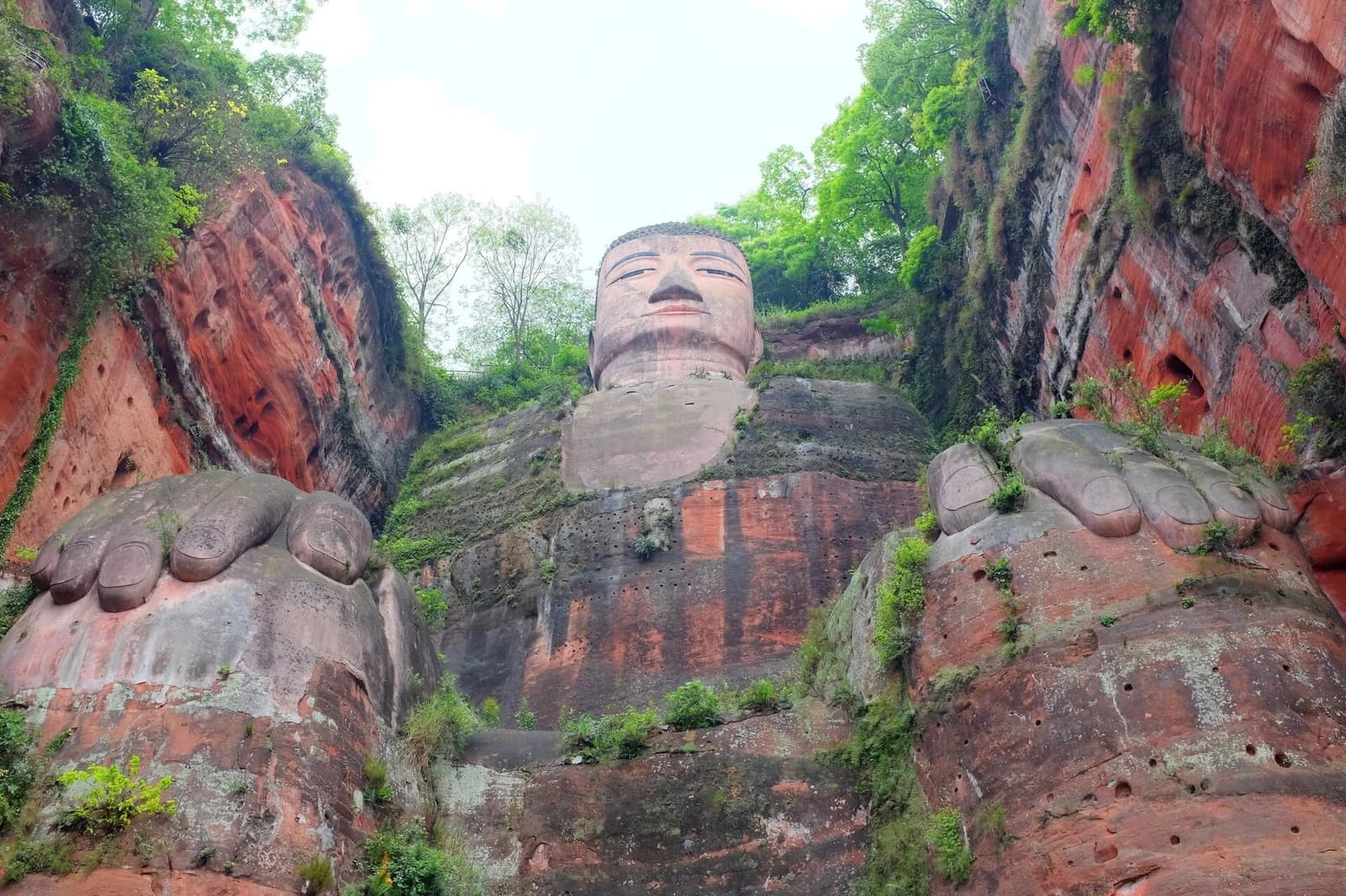 Upward view of the Leshan Giant Buddha from the lower cliff platform