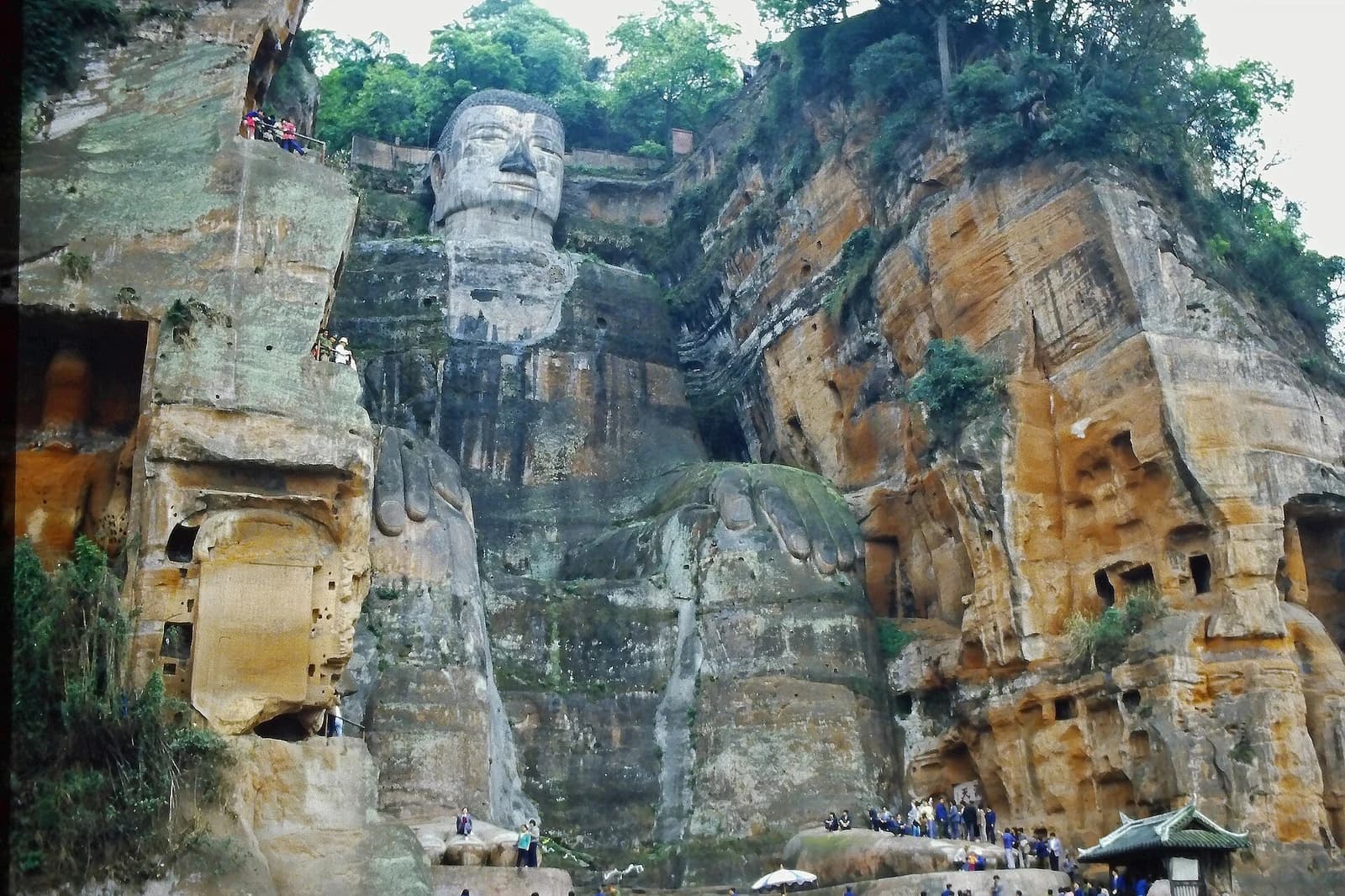 Complete frontal view of the Leshan Giant Buddha and cliff from the river