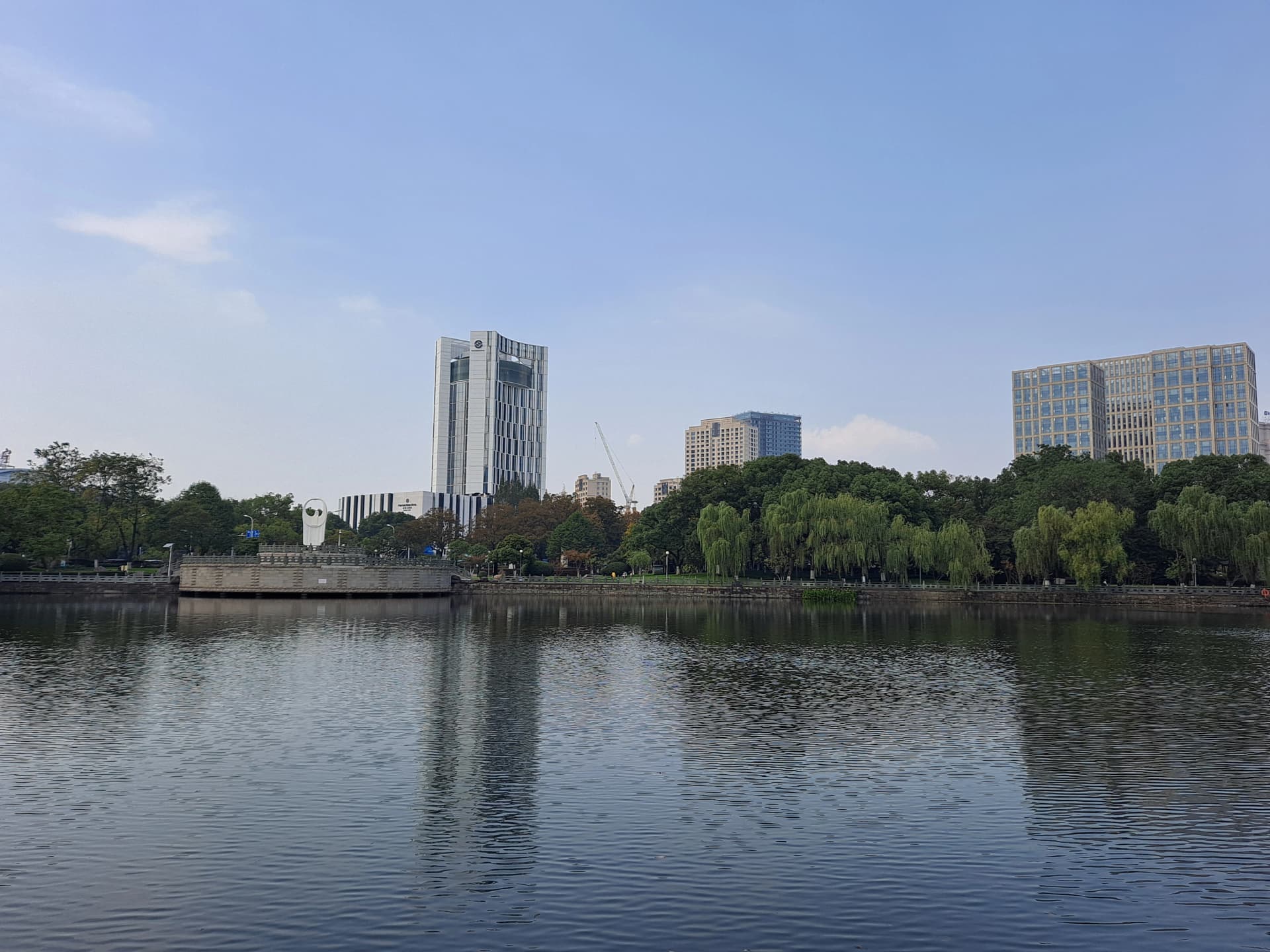 Trees and historic buildings beside Moon Lake in Ningbo