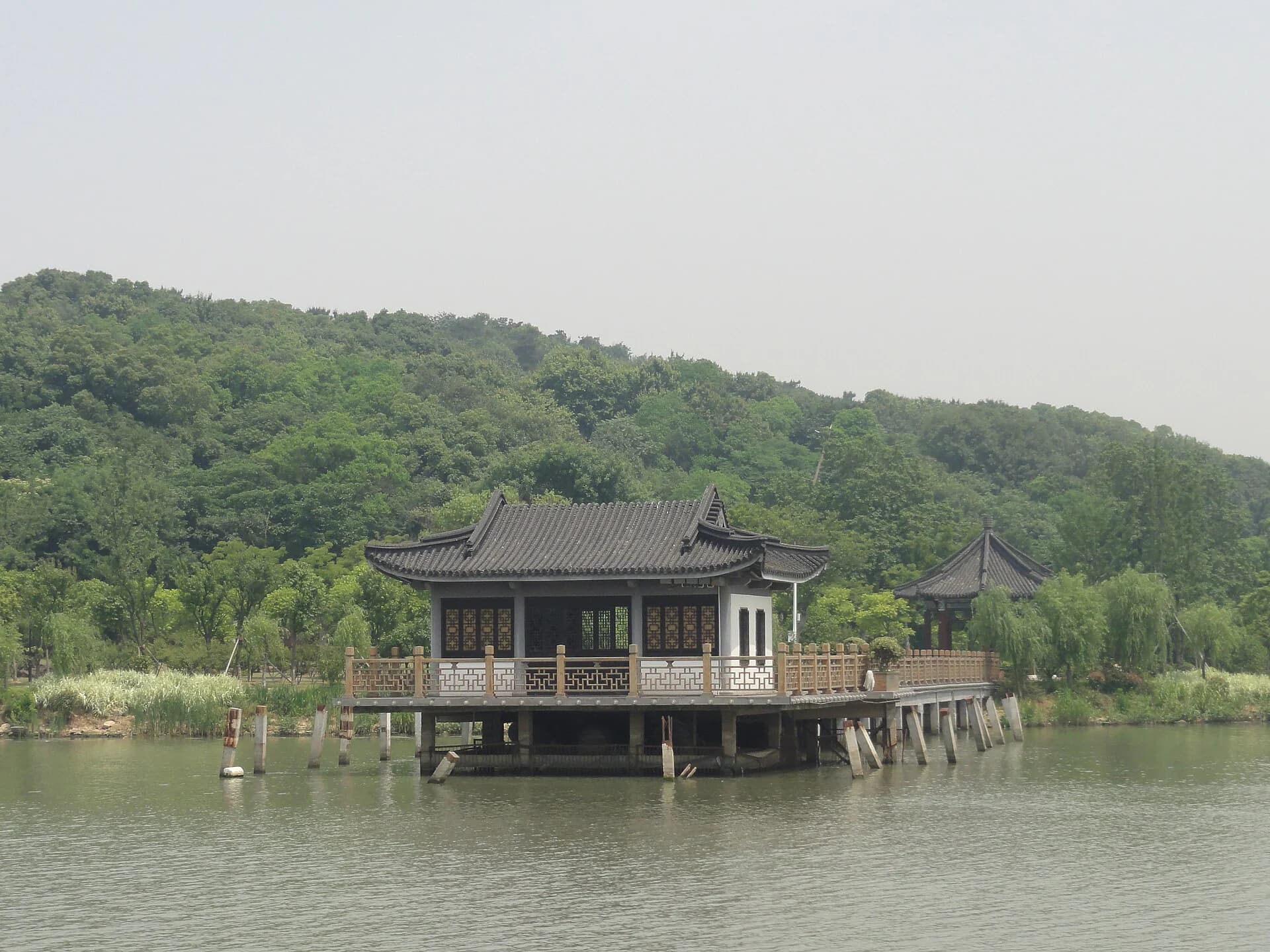 Traditional waterside pavilion among trees at Yuantouzhu