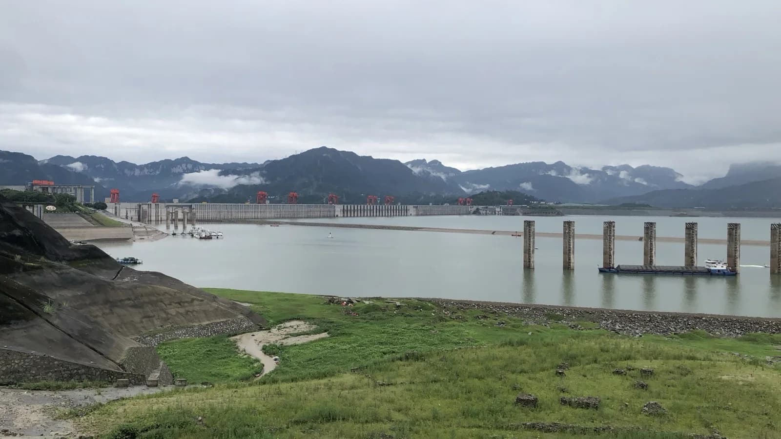 Three Gorges Dam seen across the river from an ordinary visitor viewpoint on a cloudy day