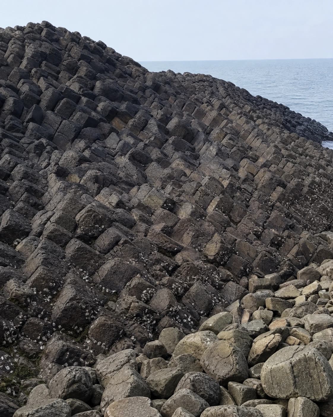 Jointed basalt and weathered volcanic rock by the coast
