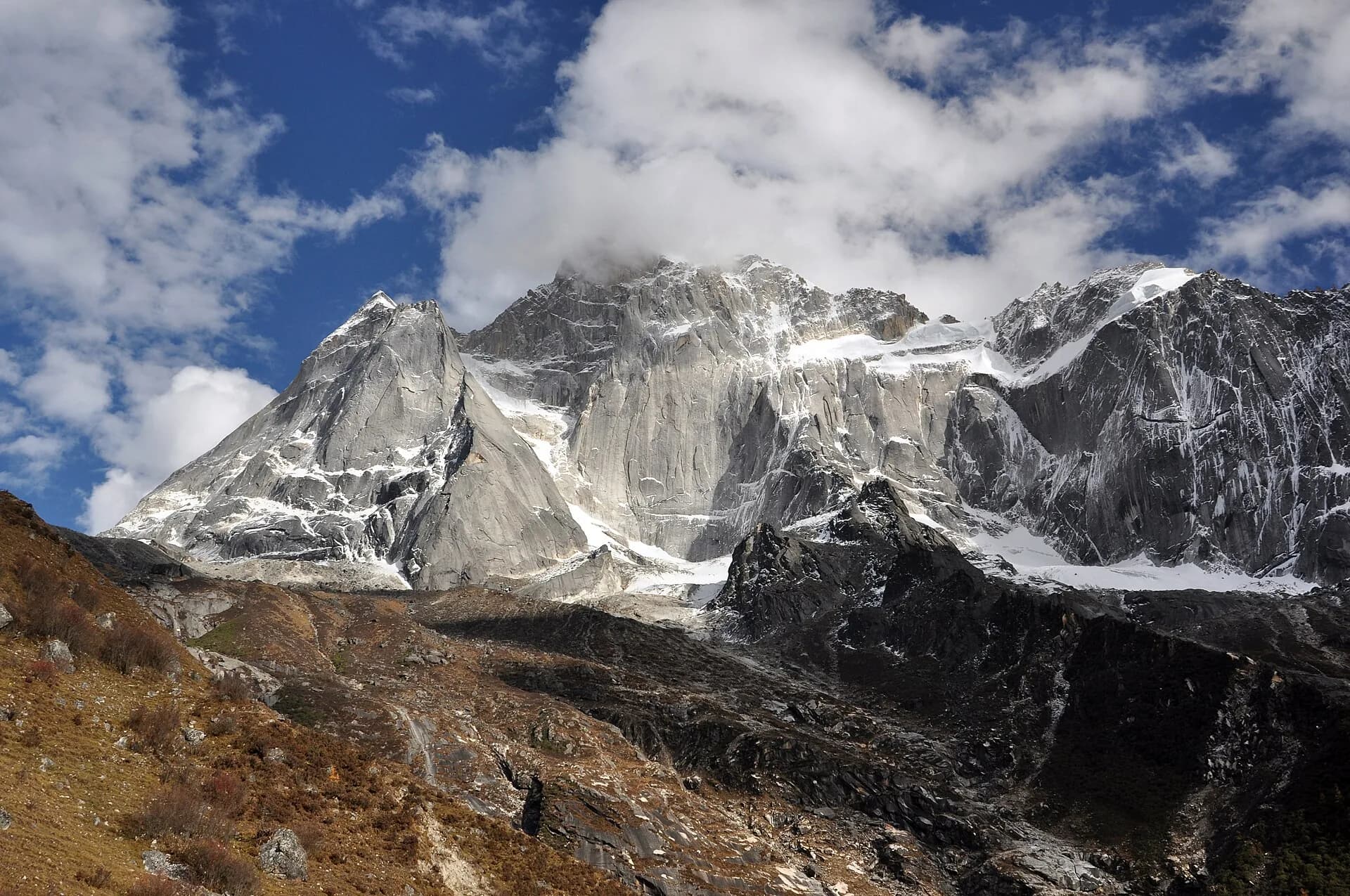 The steep north face of Yaomei Peak rising above the Mount Siguniang landscape