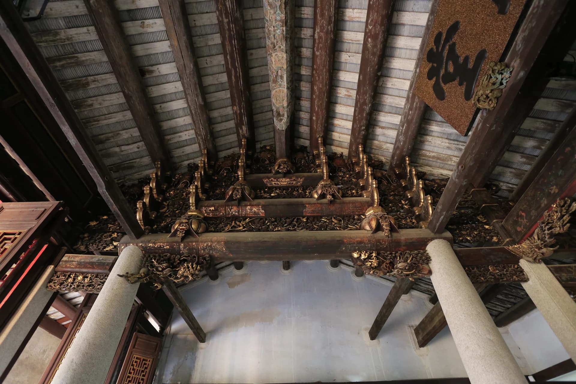 Dense gilded woodcarving beneath the roof at Jilue Huanggong Shrine in Chaozhou