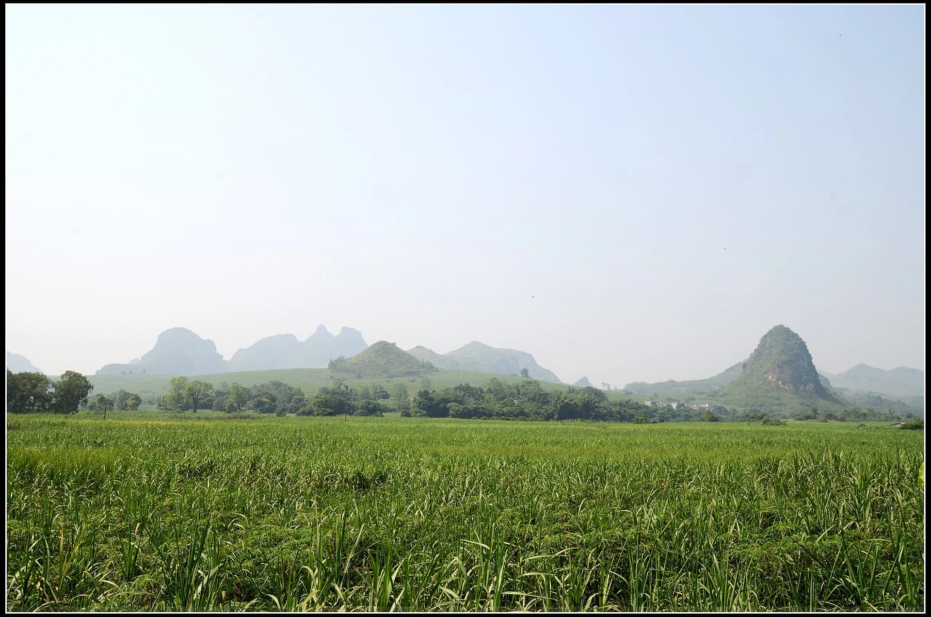 Cultivated fields below limestone peaks in the Mingshi landscape
