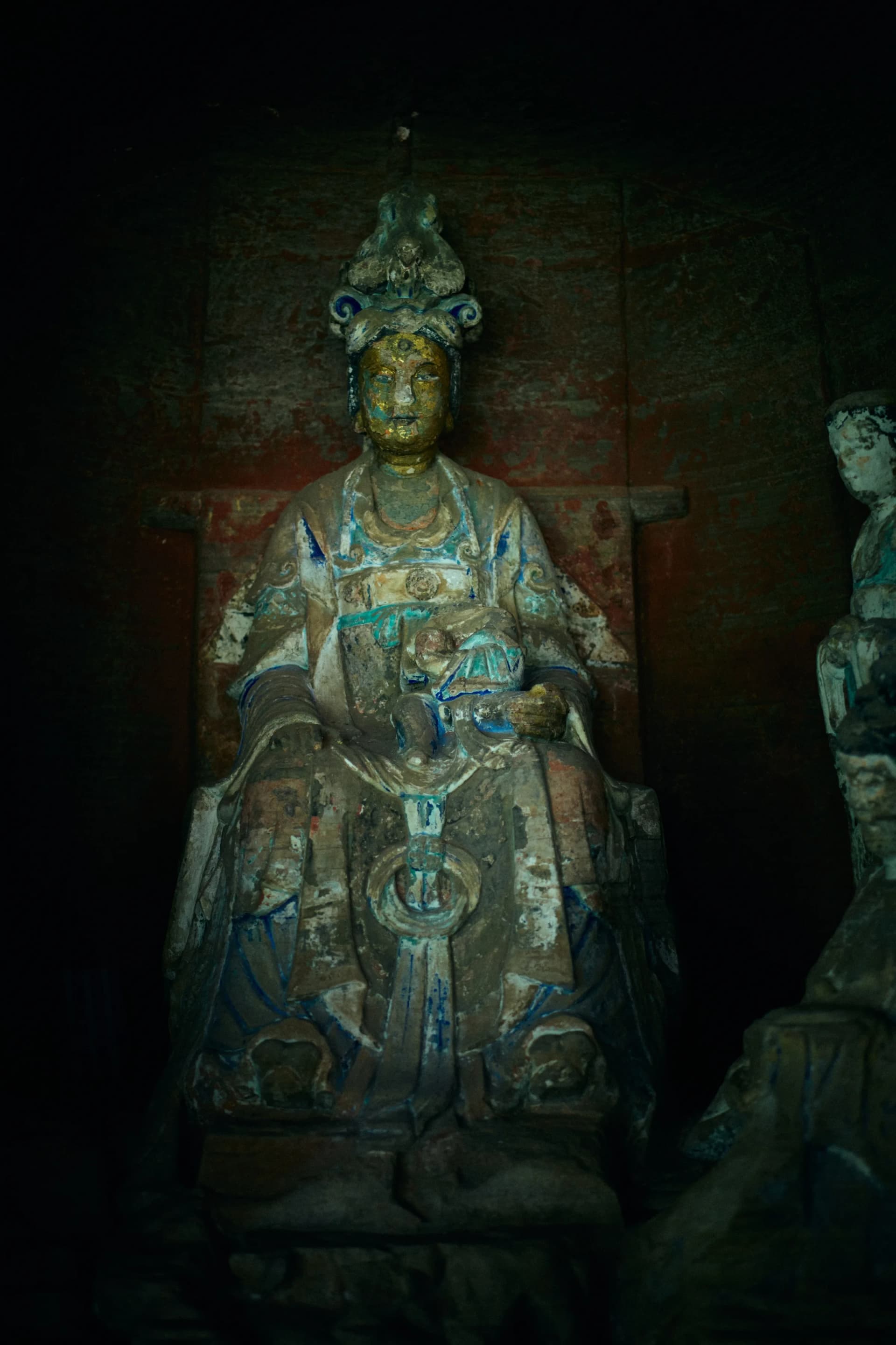 Close view of carved figures inside a Beishan rock niche