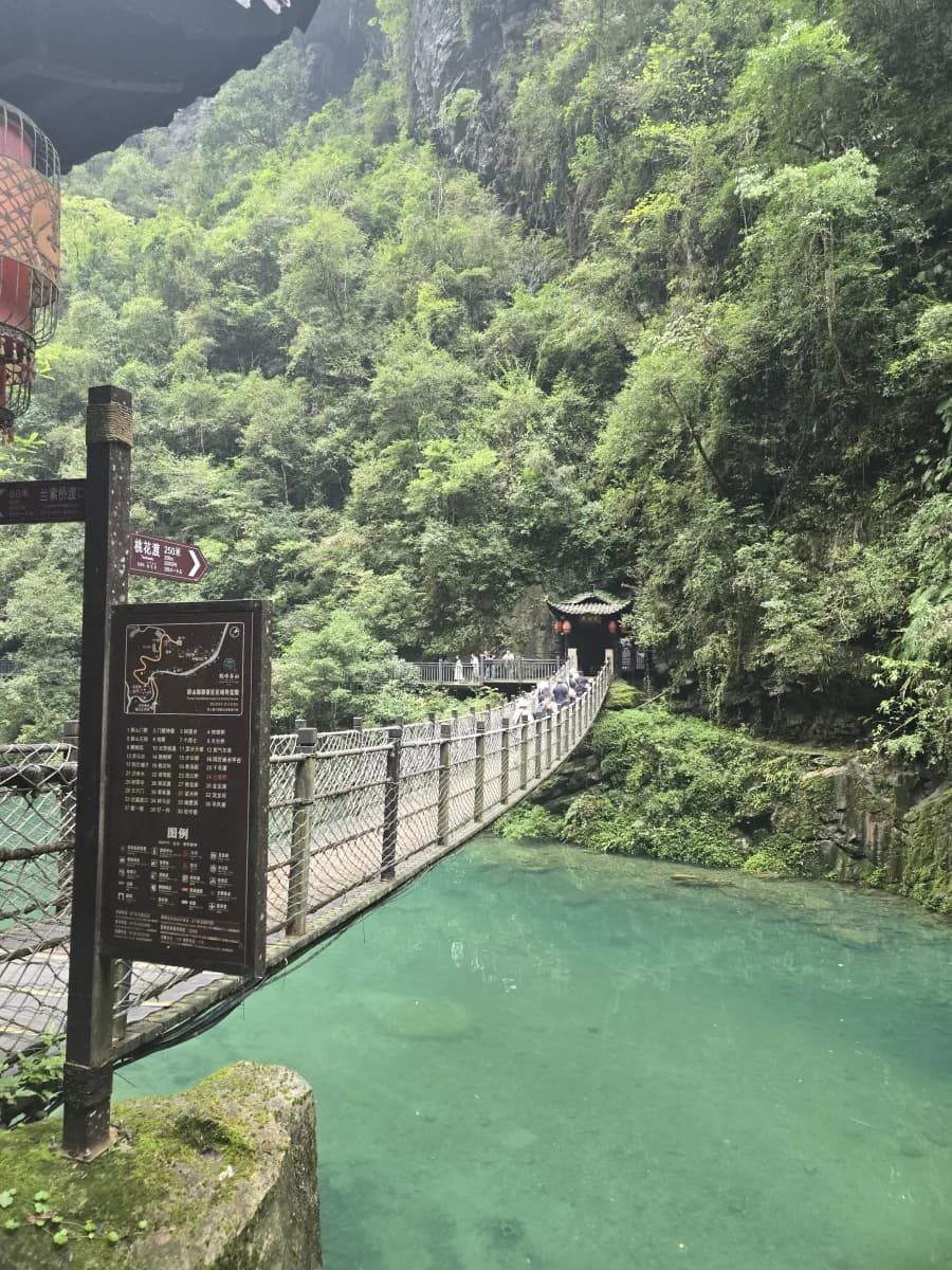 Suspension bridge and managed walking route above green water at Pingshan Canyon