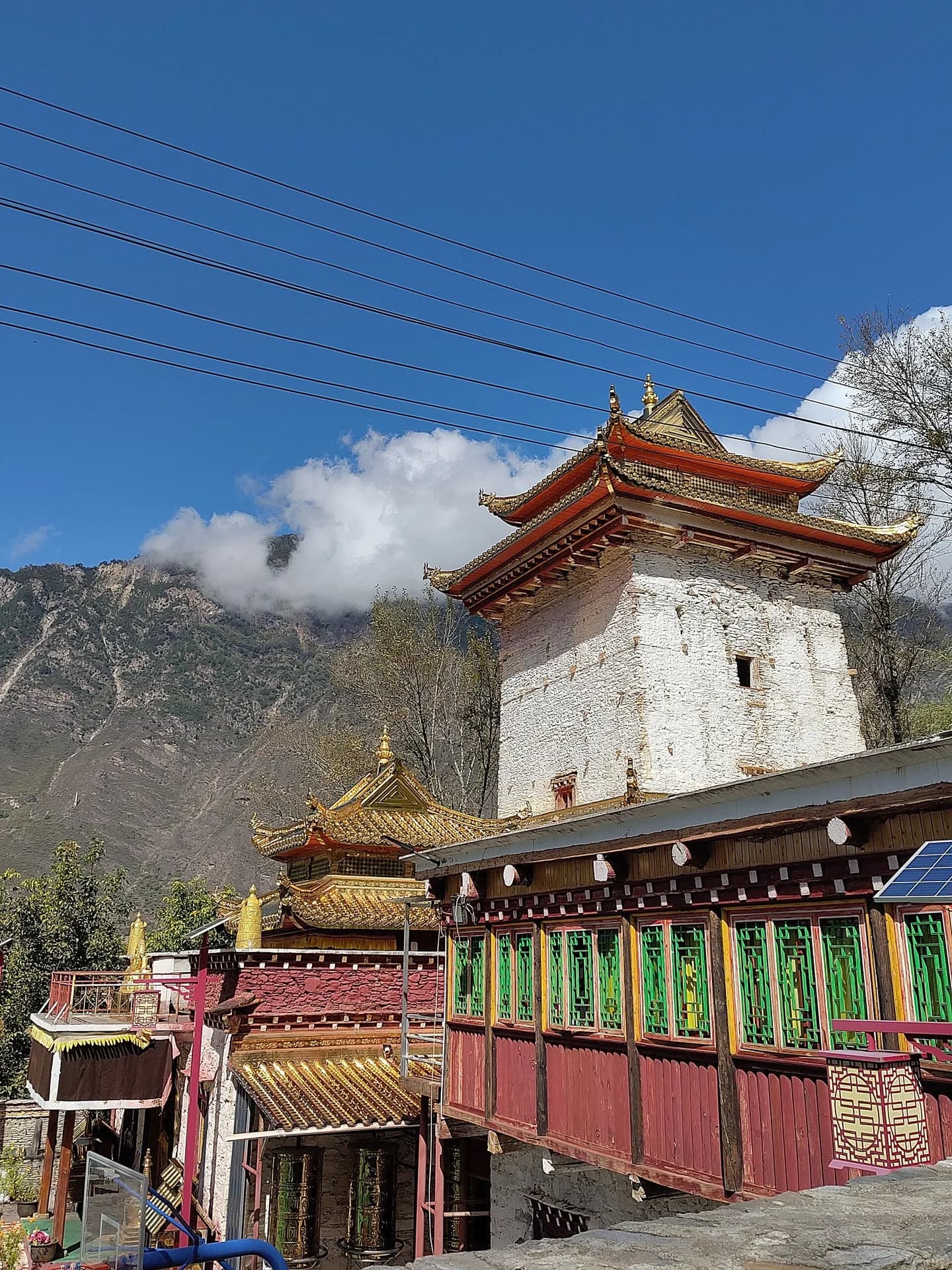 A traditional stone watchtower rising above Jika village in Danba