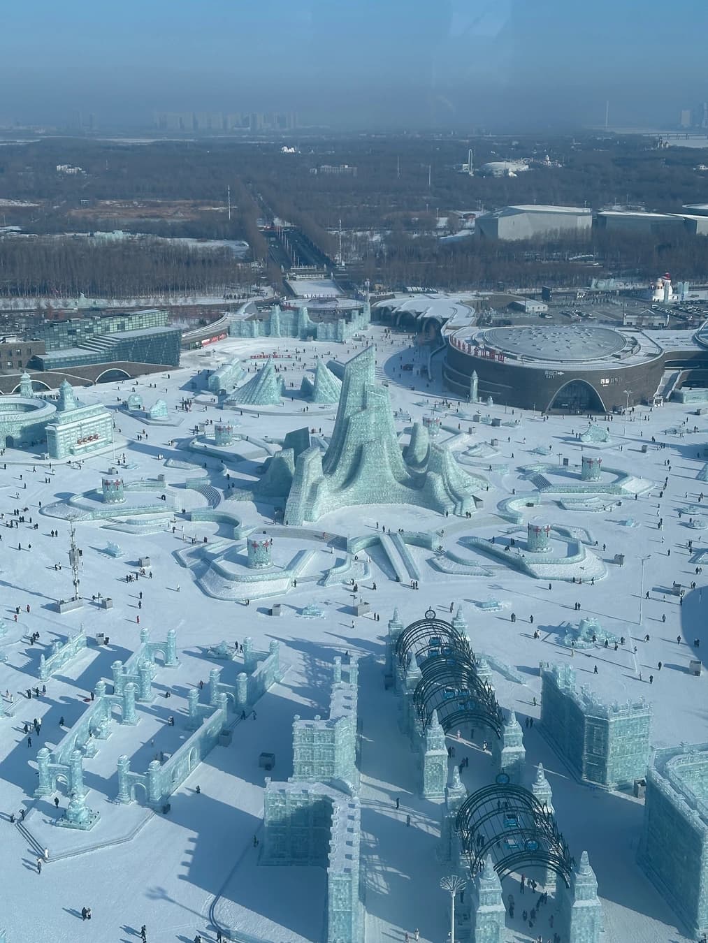 Panorama diurno del parque de hielo estacional de Harbin en construcción y funcionamiento