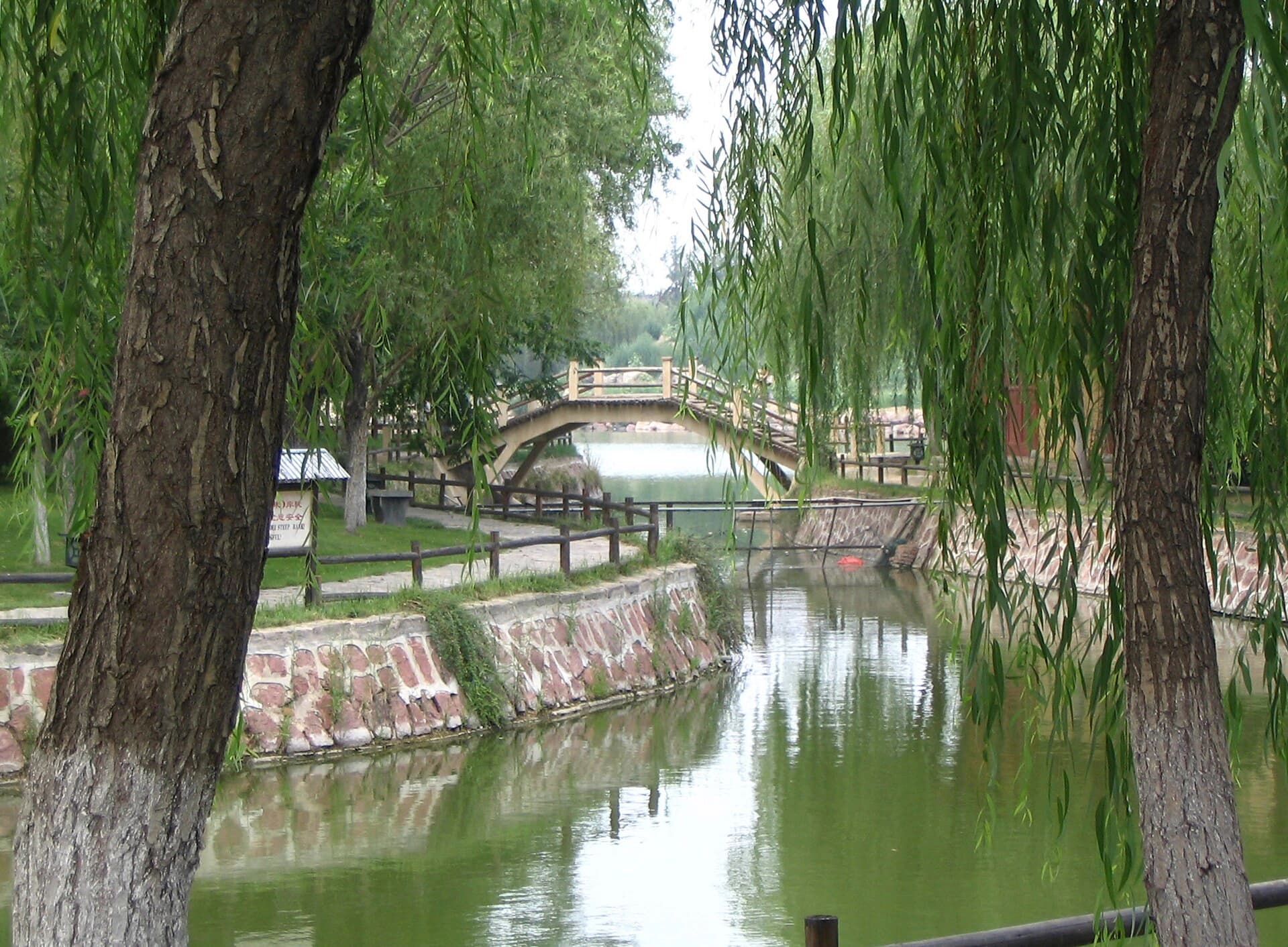 Canal, bridge and reconstructed streets inside Qingming Riverside Landscape Garden