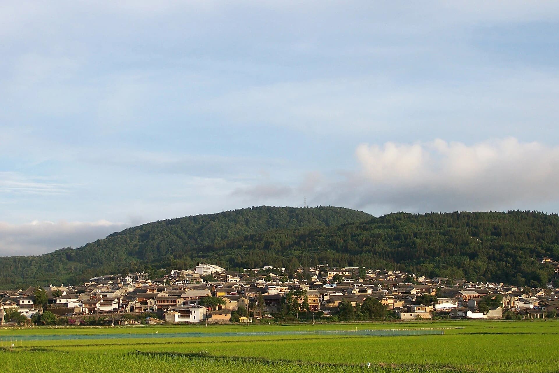Heshun settlement and fields beneath green hills in Tengchong
