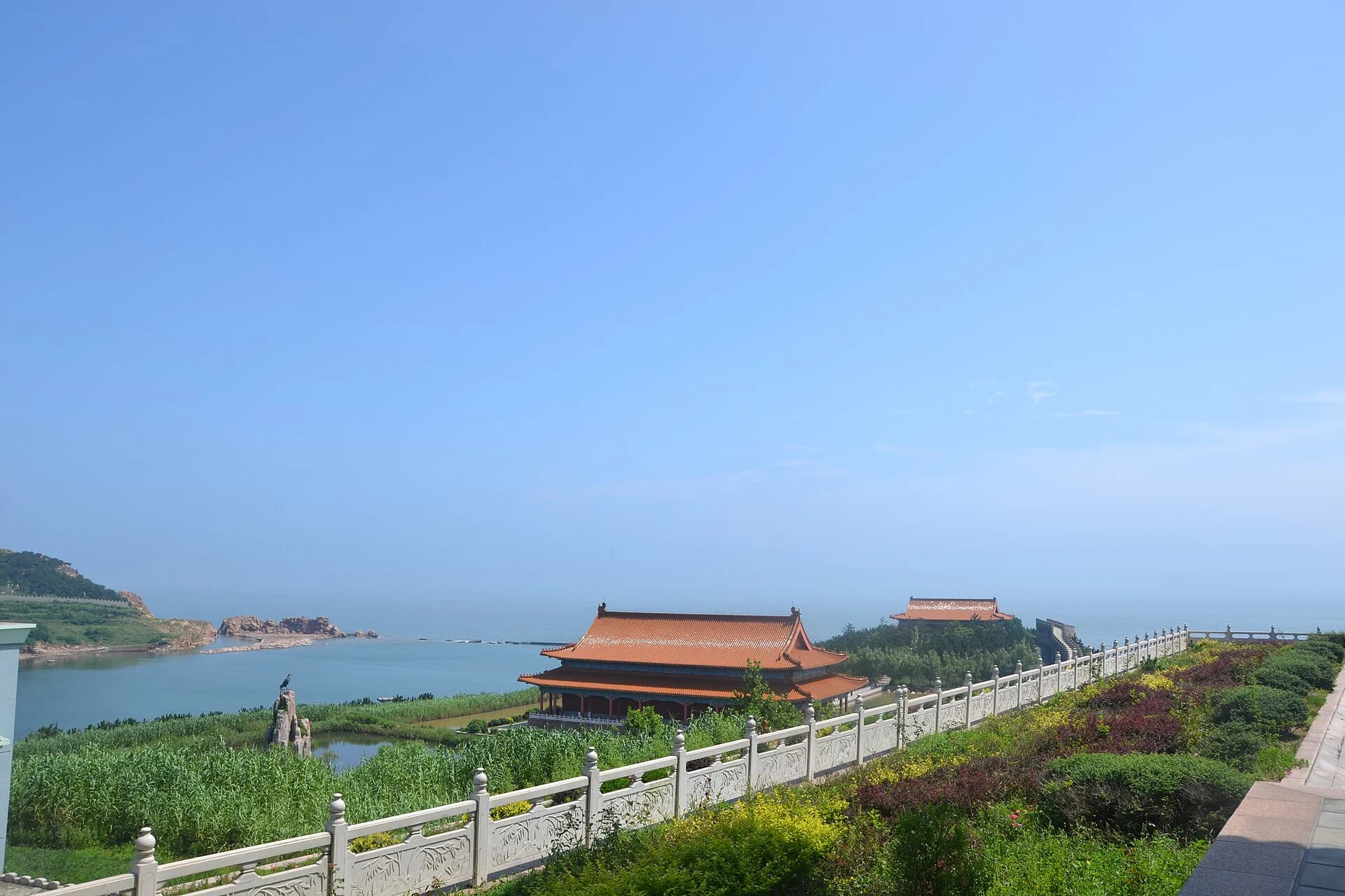 Traditional roofs, vegetation and open sea within Chengshantou