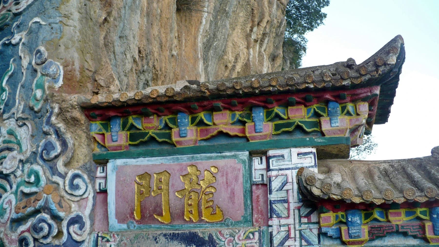 Entrada pintada de Dragon Gate encajada en el acantilado de Western Hills